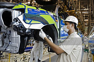 RAYONG, THAILAND - 2009/03/19: A Thai worker on the production line at the Auto Alliance automobile plant at the Hemaraj Eastern Seaboard Industrial Estate in Rayong province about 2 hours drive east of Bangkok. The factory is a joint venture between Mazda and Ford and has a monthly production capacity of 175,000 vehicles. At full tilt the factory produces a new car every 1.6 minutes. Feeling the impact of a global economic slowdown, Ford says it has cut production by about 20%, slowing its production line to a rate of one new car every 2.8 minutes. The company claims that it has not yet laid off any of its workers. A hub for auto manufacturing in Asia, Thailand is often dubbed 'the Detroit of the East'.. (Photo by Yvan Cohen/LightRocket via Getty Images)