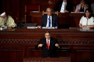 Tunisian Prime Minister Habib Essid (C-bottom) delivers a speech at the Tunisian Parliament on July 30, 2016 in the capital Tunis. The Tunisian government will face a vote of confidence in parliament that could see Prime Minister Habib Essid unseated after just a year and a half in office. Essid's government has been widely criticised for failing to tackle the country's economic crisis, high unemployment and a series of jihadist attacks. / AFP PHOTO / FETHI BELAID